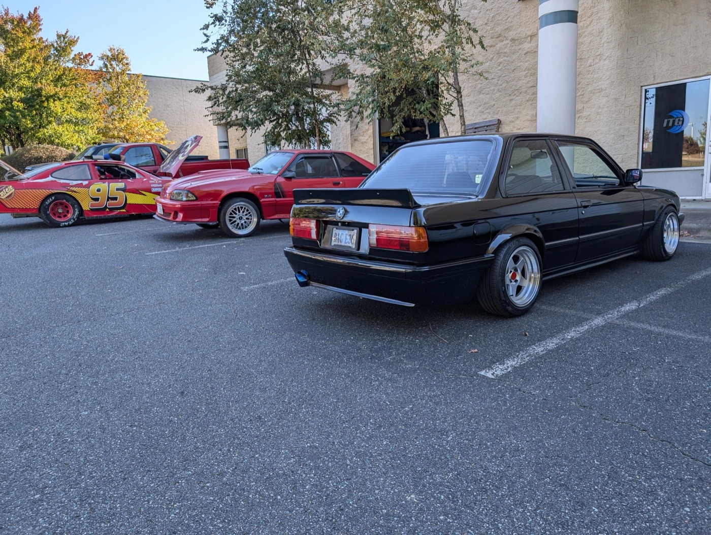 BMW and American performance cars gathered outside the shop